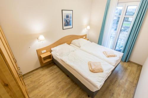 um quarto com uma cama com duas toalhas em Sunnevelt-Apartment-9 em Kühlungsborn