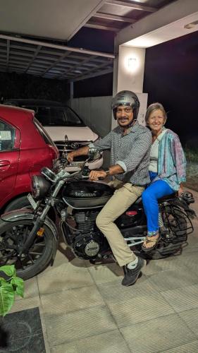 a man and a woman sitting on a motorcycle at Dreams Paradise Airport Residency in Nedumbassery