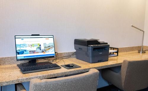 a desk with a computer and a printer on it at Holiday Inn Express & Suites Ironton by IHG in Ironton