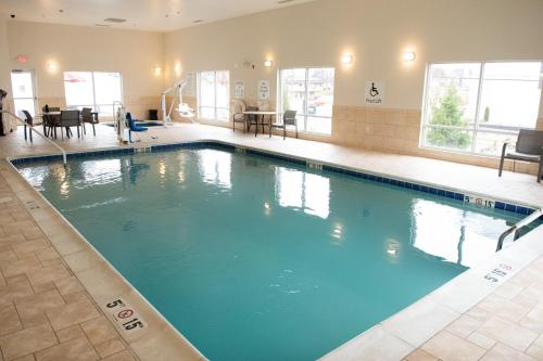 a large swimming pool with blue water in a building at Holiday Inn Express & Suites Ironton by IHG in Ironton