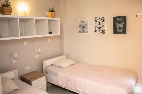 two beds in a small room with white shelves at Onefam Sants by Hostel One in Barcelona