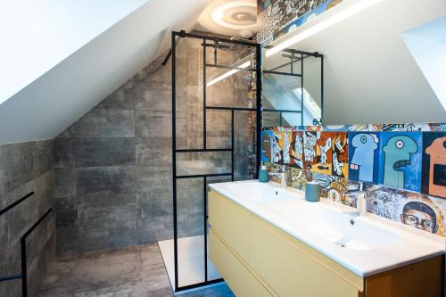 a bathroom with a sink and a mirror at Le Grand Banc - Maison typique pour 6 in Erquy