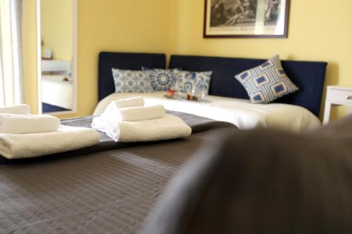 a bedroom with a bed with two towels on it at Seawall Holiday Home in Salerno