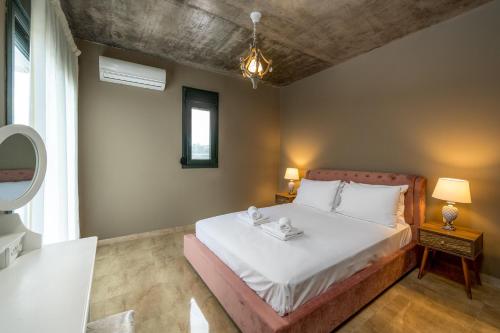 Ένα ή περισσότερα κρεβάτια σε δωμάτιο στο Alki Slow Living Villas