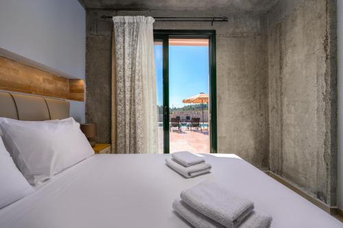 Ένα ή περισσότερα κρεβάτια σε δωμάτιο στο Alki Slow Living Villas
