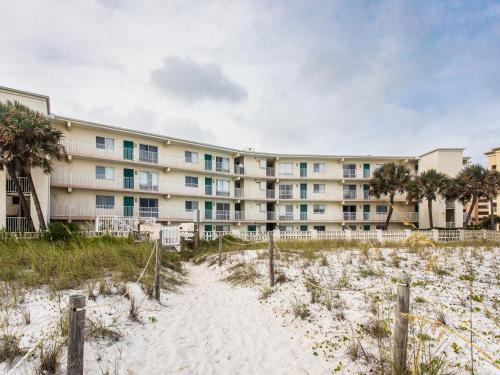 a building on the beach in front of aominium at Aqua Villa #101 in Fort Walton Beach