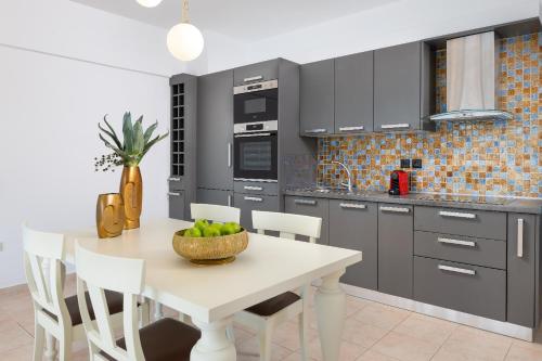 a kitchen with a table with a bowl of fruit on it at Artoria Apartment 2 First Floor in Haraki