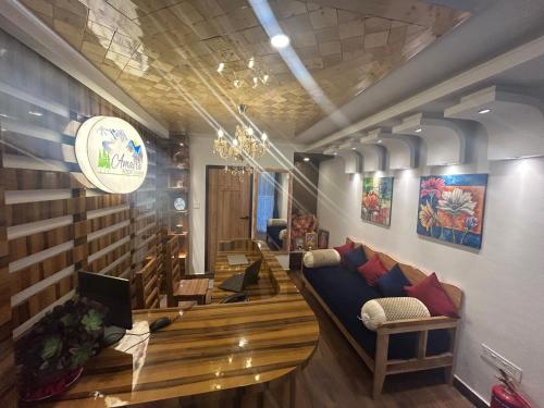 a living room with a couch and a table at Amaira Resort & Farms - Mirik, West Bengal in Mirik
