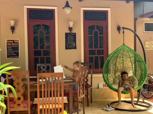 two children sitting at a table in a room at Dream Villa in Mirissa