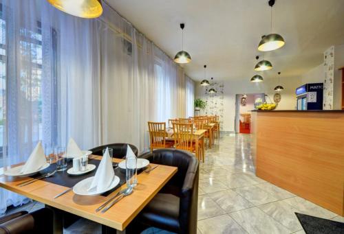 a dining room with a table and chairs and a dining room at Hotel Hvězda in Bruntál