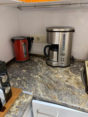 a kitchen counter with a coffee maker and a coffeemaker at City Central Apartment in Yerevan