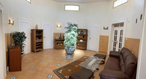 a living room with a couch and a table at Anna's garden in Torrevieja