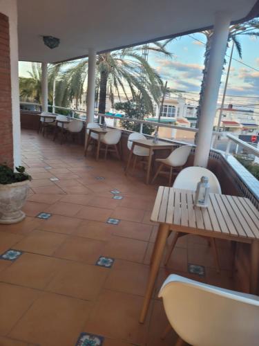 a restaurant with tables and chairs on a balcony at Anna's garden in Torrevieja