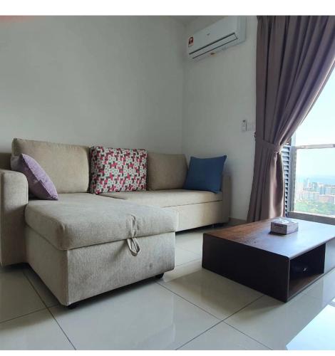 a living room with a couch and a coffee table at Woodsbury Suites 7722 Butterworth Penang in Butterworth