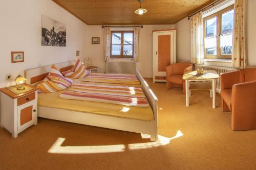 a bedroom with a bed and a living room at Ferienwohnung Nöß in Pfronten