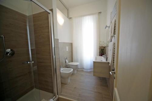 a bathroom with a shower and a toilet and a sink at Seawall Holiday Home in Salerno