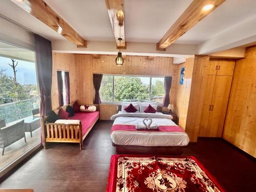 a bedroom with two beds and a large window at Amaira Resort & Farms - Mirik, West Bengal in Mirik