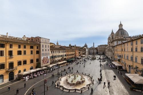 a city street with a fountain in the middle at Navona 49 Luxury Suites&Apartment in Rome