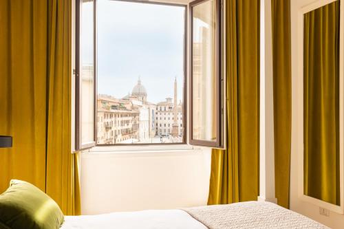 a bedroom with a window with a view of a city at Navona 49 Luxury Suites&Apartment in Rome