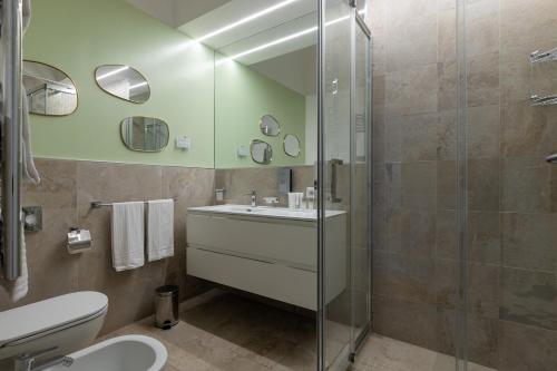 a bathroom with a shower and a sink and a toilet at Navona 49 Luxury Suites&Apartment in Rome