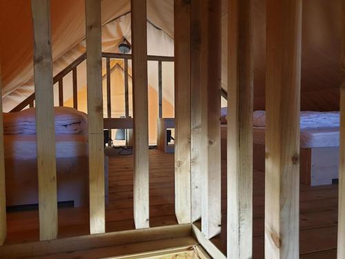 a view of a wooden room with two beds at Safaritent Betuwe Lodge in Kesteren