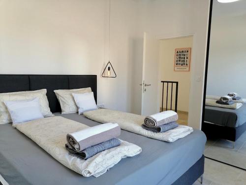 a bedroom with two beds with towels on them at Villa Bora - Ferienhaus am Meer in Slatine