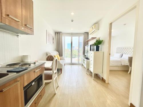 a kitchen and a living room with a bedroom at Town Sukhumvit 71 in Bangkok
