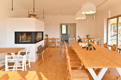 uma sala de jantar com uma grande mesa de madeira e cadeiras em Eko Glamping Resort Krištof em Cerklje na Gorenjskem