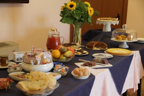 a table with a blue table cloth with food on it at Agriturismo La Fattoria in Norcia