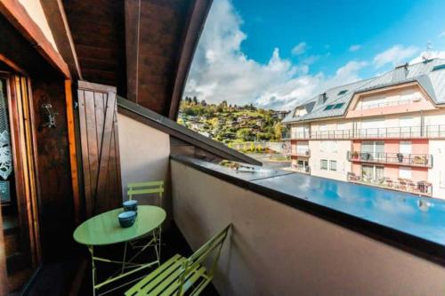 a balcony with a table and chairs and a view at Cocon familial proche télécabine in Saint-Gervais-les-Bains
