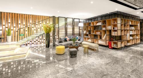 a living room with a couch and a table at Atour Hotel Changsha International Covention Centre South Railway Station in Changsha