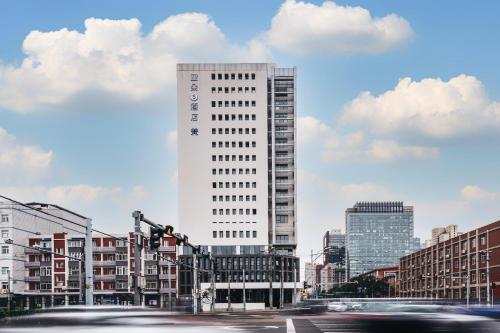 a tall white building in the middle of a city at Atour S Hotel Beijing Guomao CBD - FunsCenter in Beijing