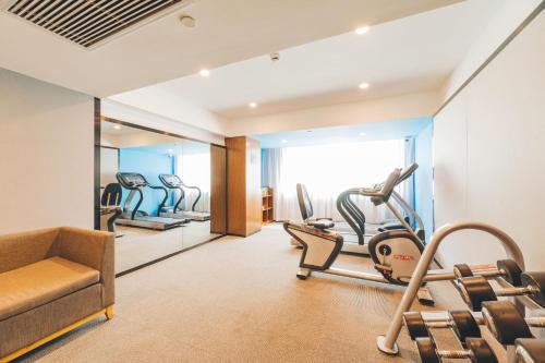 a gym with cardio equipment in a hotel room at Atour Hotel New International Expo Center Longyang Road Shanghai in Shanghai