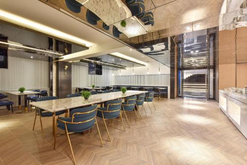 an office lobby with a long table and chairs at Atour Hotel Beijing Chaoyangmen in Beijing