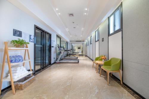 an office corridor with chairs and tables and windows at Atour Hotel Three Lanes and Seven Alleys Fuzhou in Fuzhou