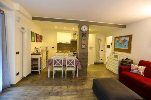 a living room and kitchen with a table and a couch at Tizi House in Varenna