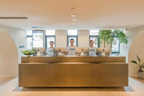 a group of women standing at a counter in an office at Atour S Hotel Beijing Guomao CBD - FunsCenter in Beijing
