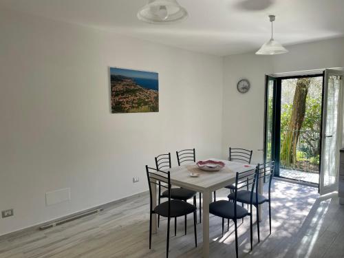a dining room with a table and chairs at Sorrento Realty Holidays - The smile of the sun in Sorrento
