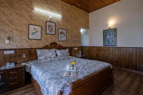 a bedroom with a large bed with shoes on it at Villa Mountain Crest Kasauli with Treehouse & Sundeck in Dagshai
