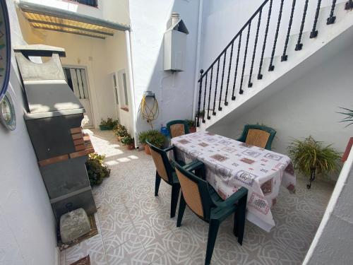 une terrasse avec une table, des chaises et un escalier. dans l'établissement Casa Andrés, à Arriate