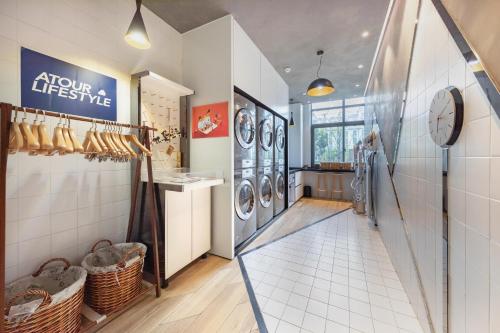 a laundry room with washing machines and a window at Atour Hotel Hongqiao Hub National Exhibition Center Shanghai in Shanghai