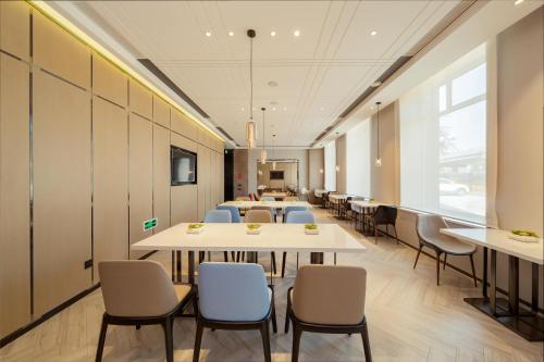 a row of tables and chairs in a room at Atour Hotel Harbin Convention and Exhibition Center Nongken in Harbin