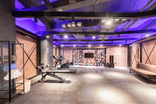 a gym with purple lighting and a fitness center at Atour Hotel Shenzhen Nanshan Qianhai Yiche in Shenzhen