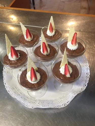 a tray of chocolate desserts with strawberries on them at Lolli Palace Hotel in Sanremo