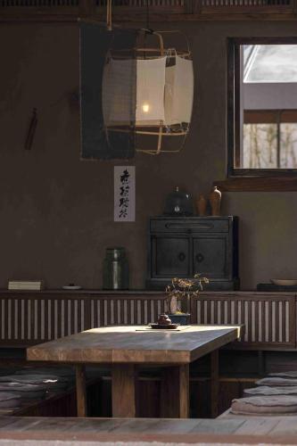 a kitchen with a wooden table and a window at Sahe Hotel Shanghai World Expo in Shanghai