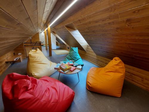 a room with two bean bags and a table and chairs at Rezidence Za Vodou - Ledňáček in Cerny Dul