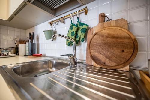 a kitchen sink with a wooden cutting board next to it at YID Oltrarno segreto in Florence