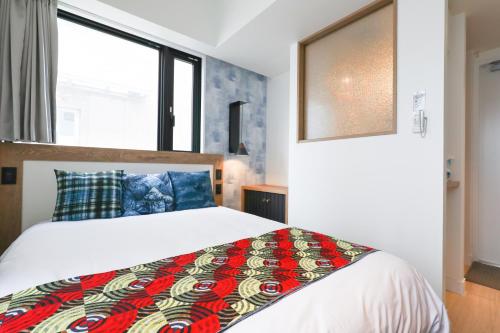 Un ou plusieurs lits dans un hébergement de l'établissement FFFFFF Hotel エフホテル