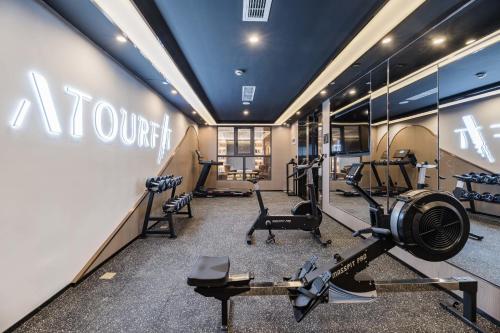a gym with several treadmills and machines in it at Atour Hotel Suzhou Guanqian Street in Suzhou