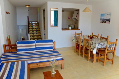 a living room with a table and a dining room at Trill Mirasol C primera linea mar L'Estartit in L'Estartit